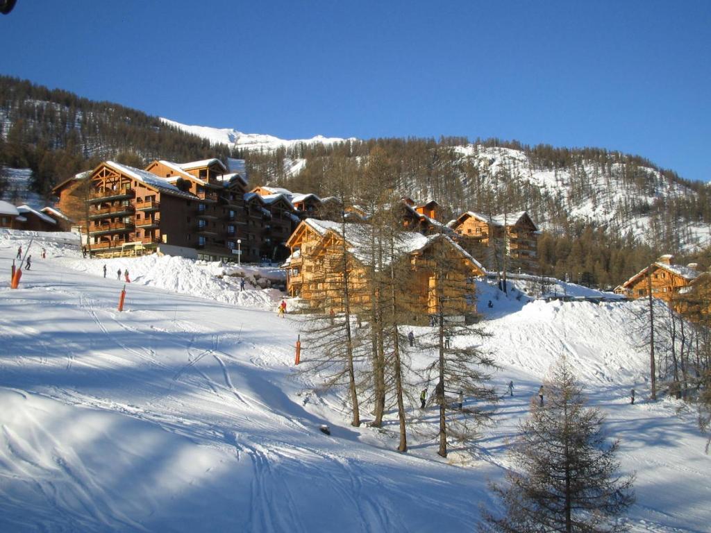 a ski lodge in the snow with trees and snow at Residence la Dame Blanche in Puy-Saint-Vincent
