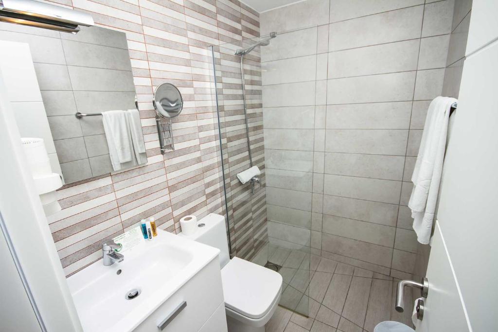 a bathroom with a toilet and a sink and a shower at IG Nachosol Atlantic & Yaizasol by Servatur - Adults Only in Puerto Rico de Gran Canaria