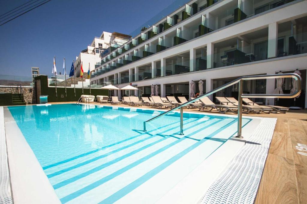 a large swimming pool on the side of a building at IG Nachosol Atlantic & Yaizasol by Servatur - Adults Only in Puerto Rico de Gran Canaria