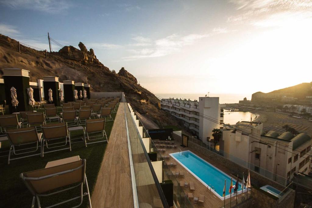 a balcony with a swimming pool on top of a building at IG Nachosol Atlantic & Yaizasol by Servatur - Adults Only in Puerto Rico de Gran Canaria