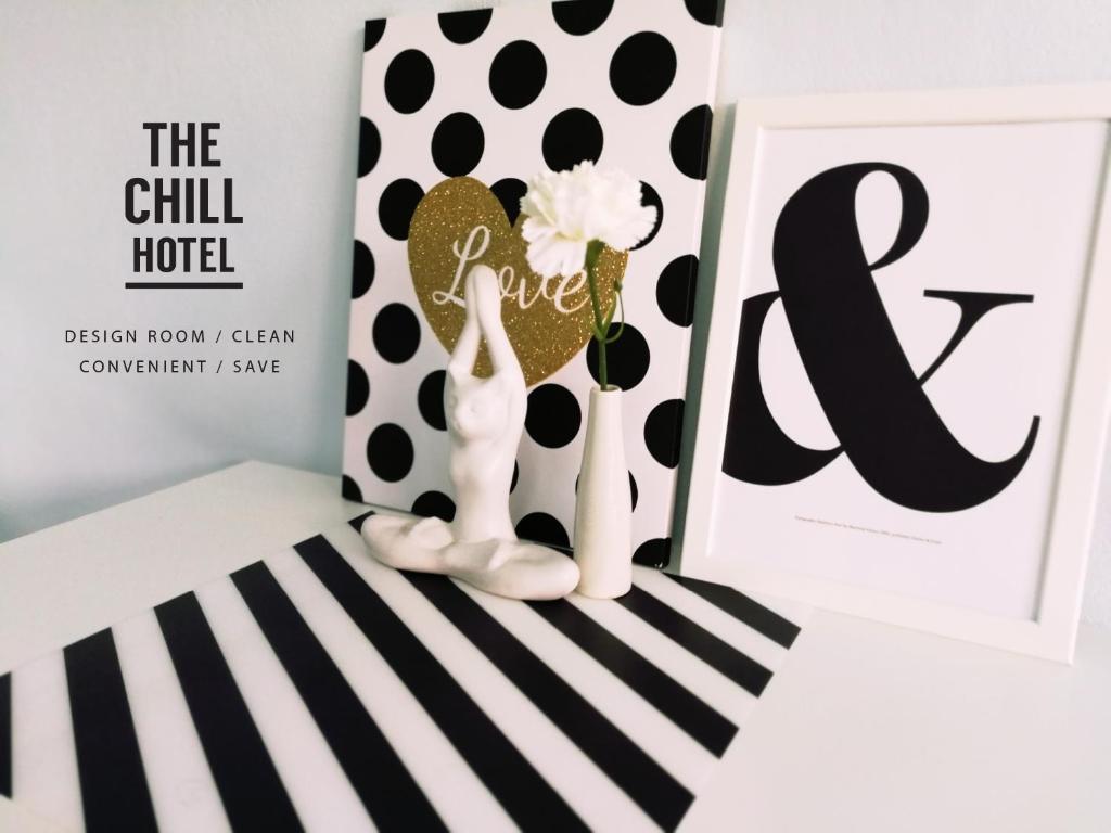 a book review of the chill hotel with a white and black striped box with at The Chill Town Home in Maha Sarakham