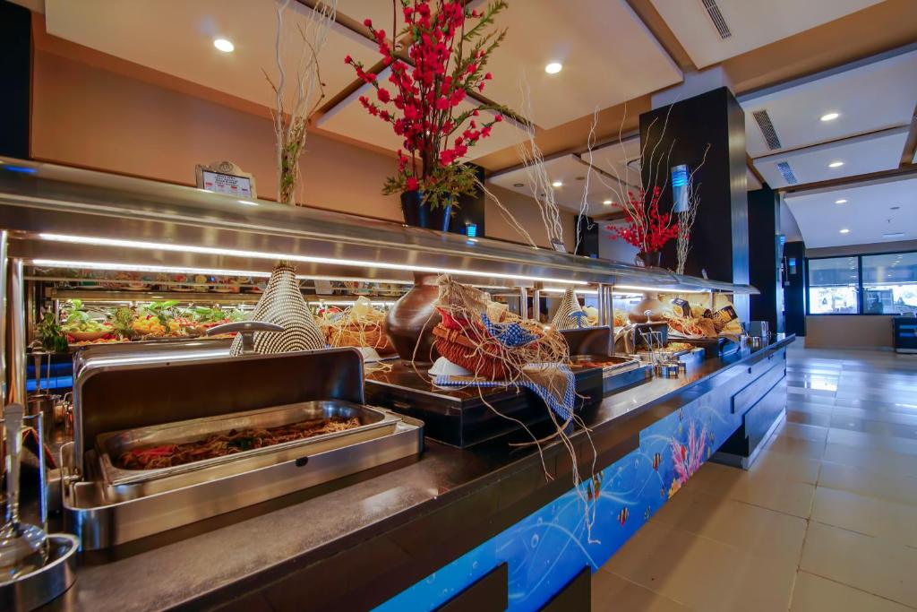 a buffet line of food in a restaurant at Limak Atlantis Deluxe Hotel Belek in Belek