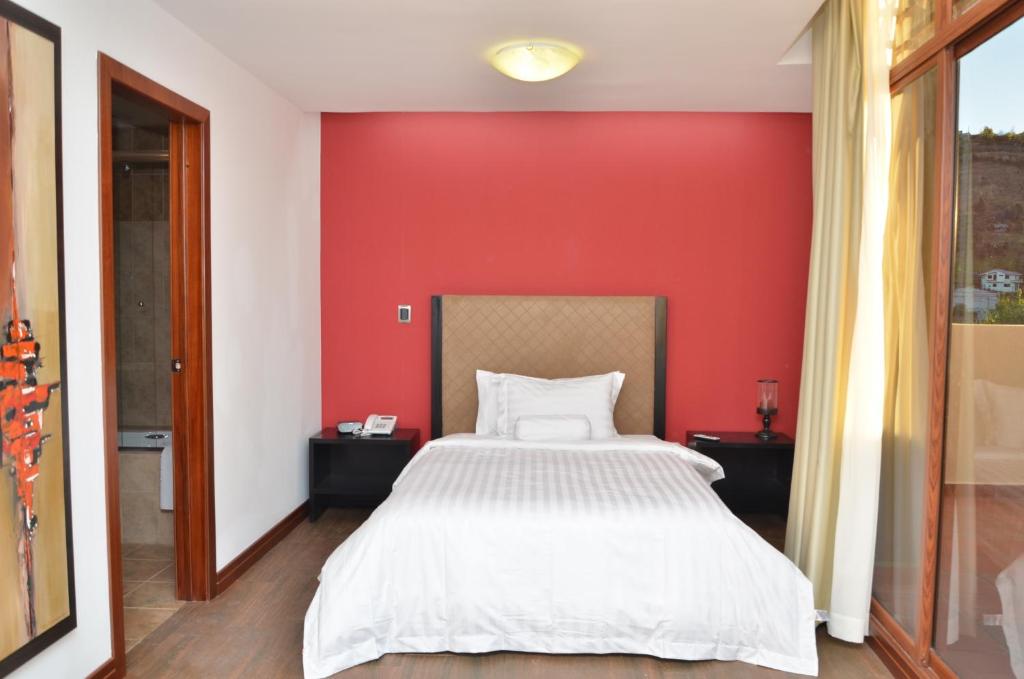 Postel nebo postele na pokoji v ubytování Arhaná Hosteria & Resort