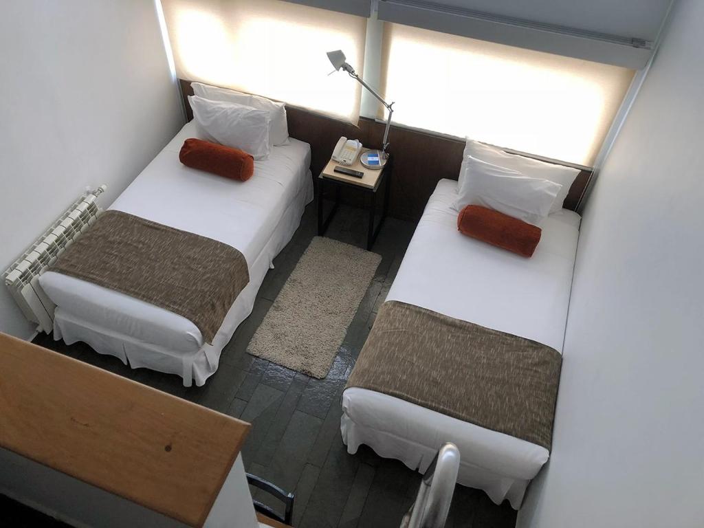 Postel nebo postele na pokoji v ubytování Natalino Hotel Patagonia