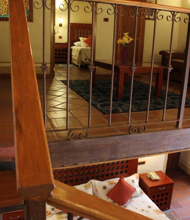Postel nebo postele na pokoji v ubytování Hotel Quinta Santiago