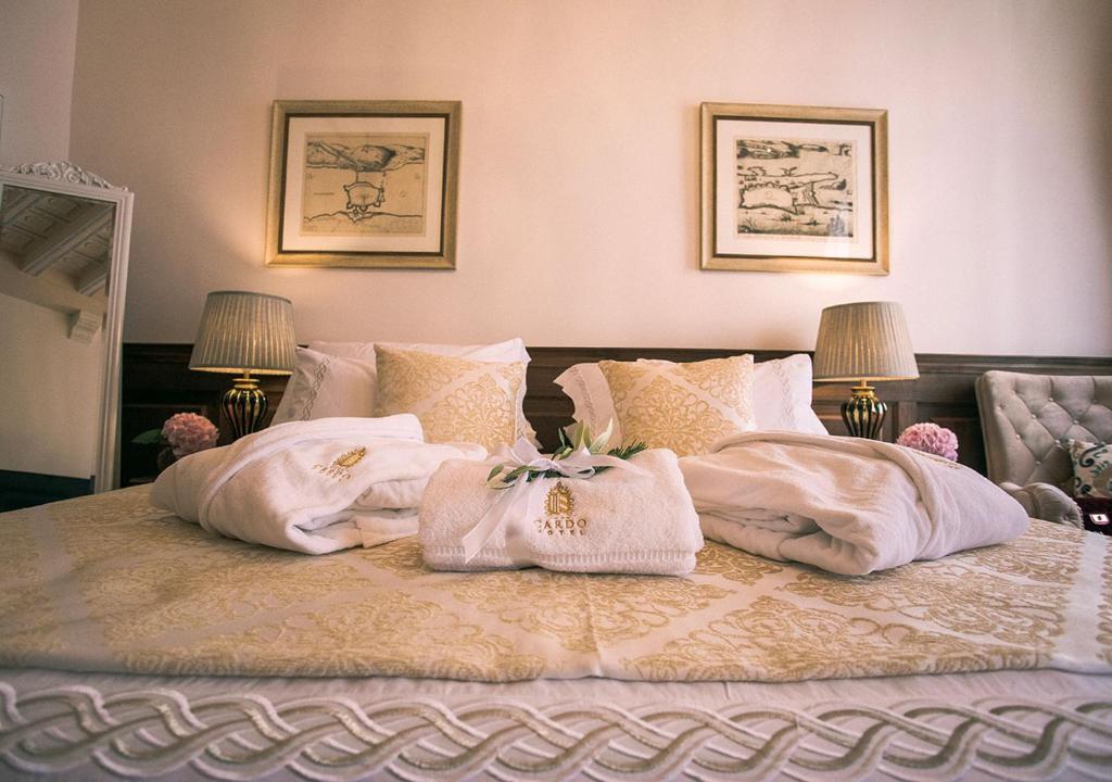 a bedroom with a bed with towels on it at Heritage Hotel Cardo in Split