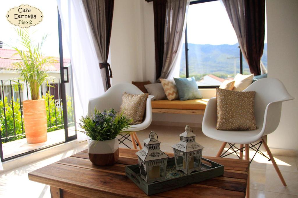 a living room with a couch and chairs and a table at Casa Dornella - Casa de Hospedaje in Guaduas