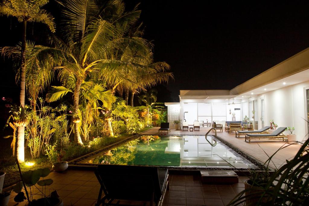 a house with a swimming pool at night at Angkor Private villa Siem Reap in Siem Reap
