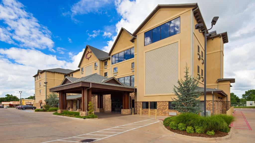 a large building with a large screen in front of it at Best Western PLUS Cimarron Hotel & Suites in Stillwater