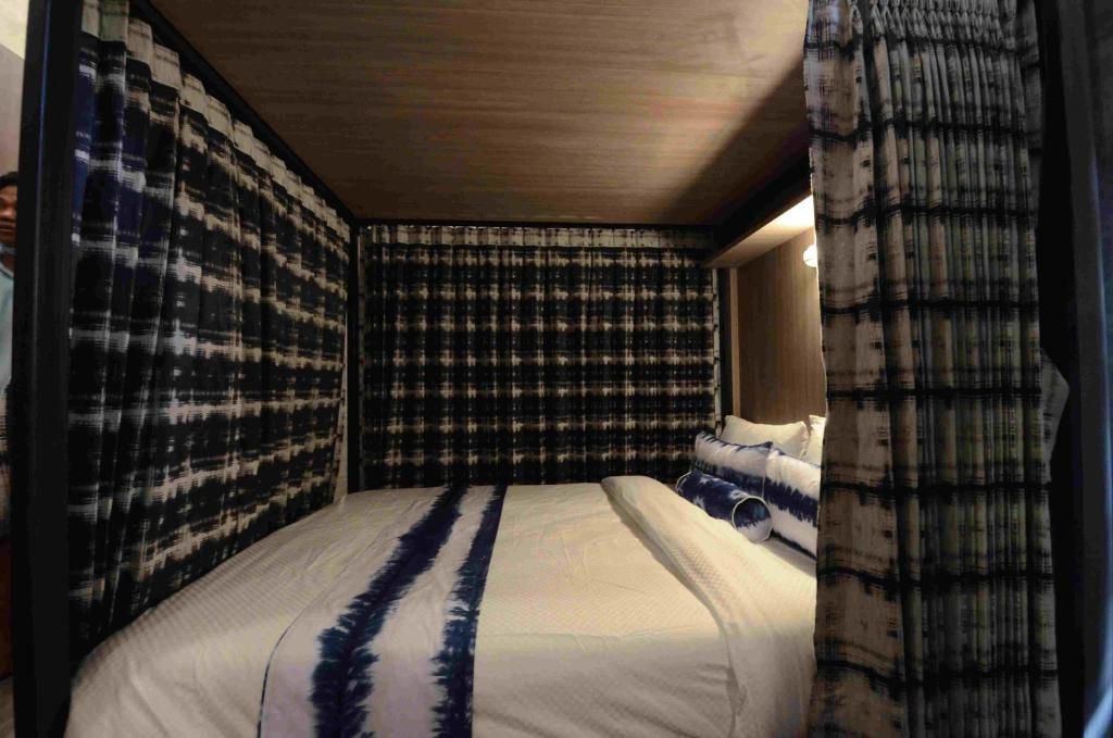 a small bed in a room with curtains at The Chic Lipe in Ko Lipe