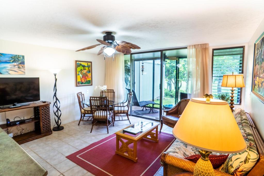 a living room with a couch and a table at Elegant Turtle Bay Condo in Kahuku