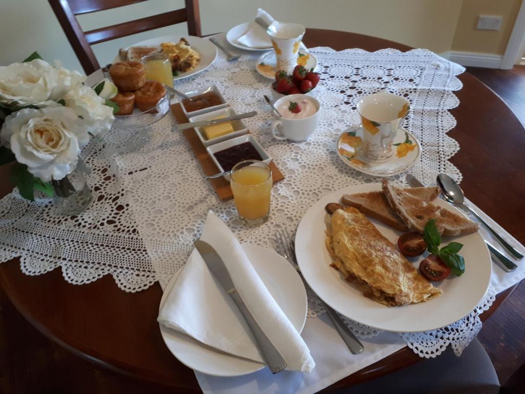 a table with a plate of breakfast food on it at Robin's Nest B&B in Wilmot