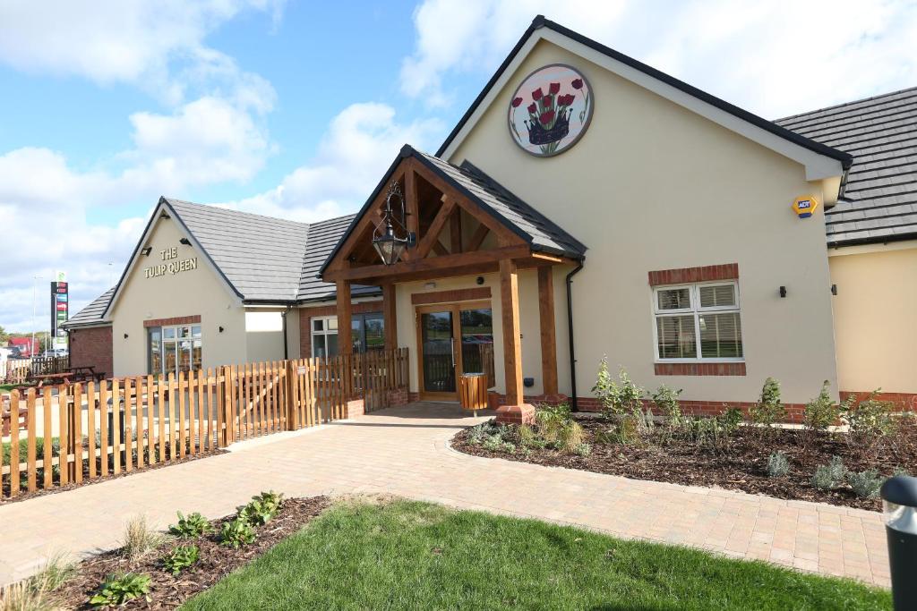 a house with a wooden fence around it at Tulip Queen, Spalding by Marston's Inns in Spalding