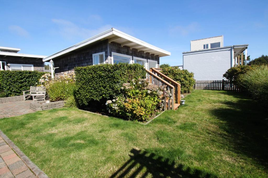 a house with a yard with a fence at Periwinkle in Pacific Beach