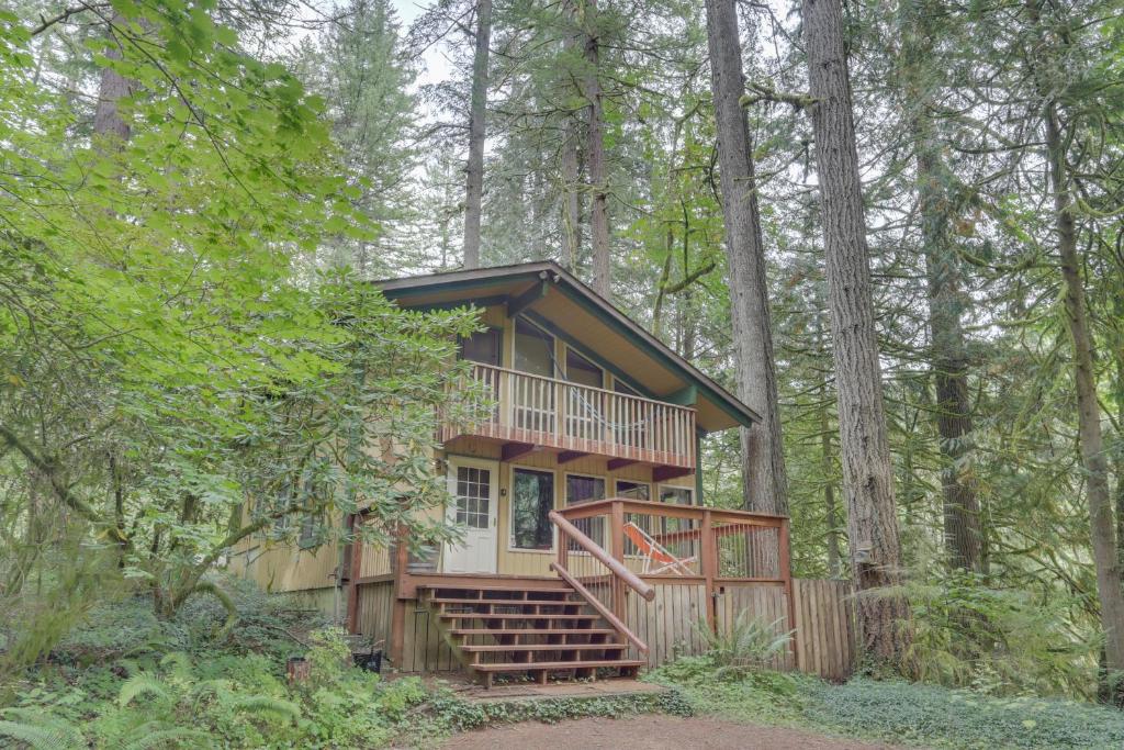 a tree house in the woods with a deck at Rivers Perch in Washougal