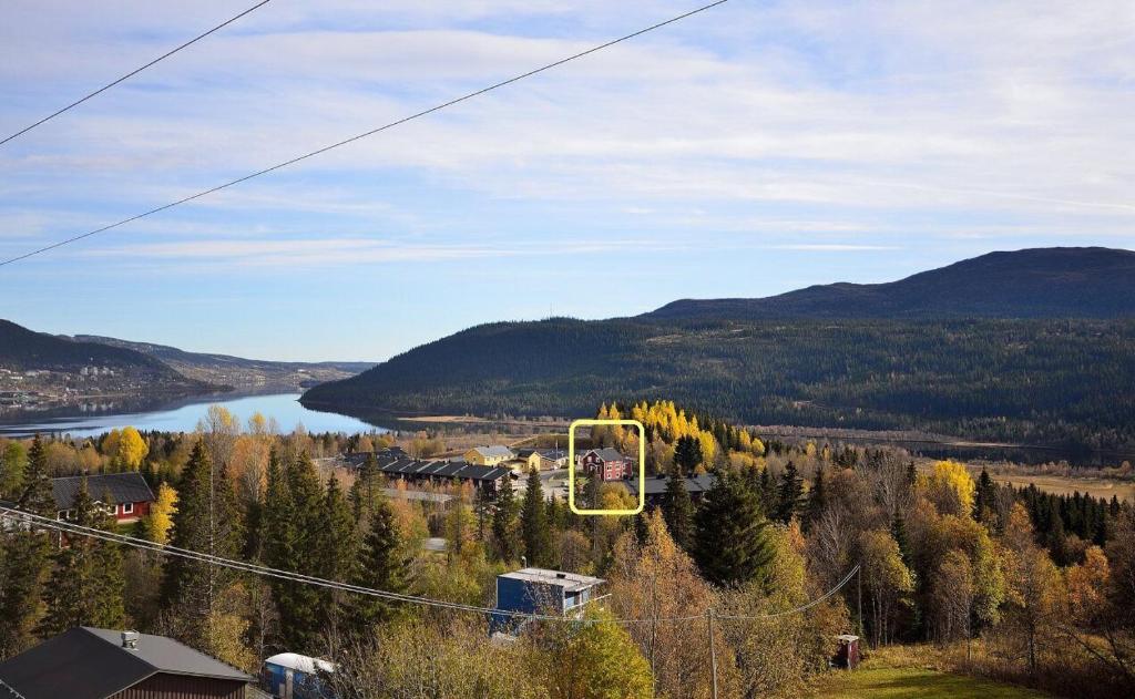 a gondola ride up a hill with a river and mountains at Åre Kläppen in Åre