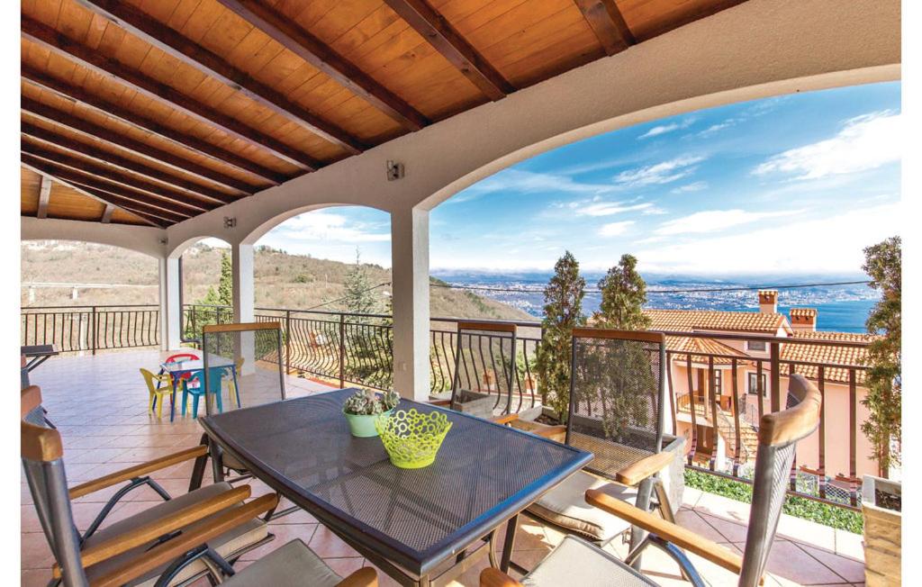 a patio with a table and chairs on a balcony at Petra Hills in Opatija