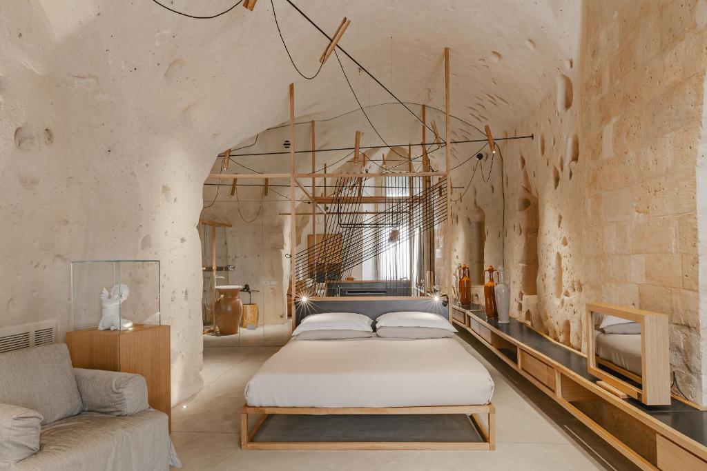 a bedroom with a bed and a couch at Ai Maestri Rooms&Cafè in Matera