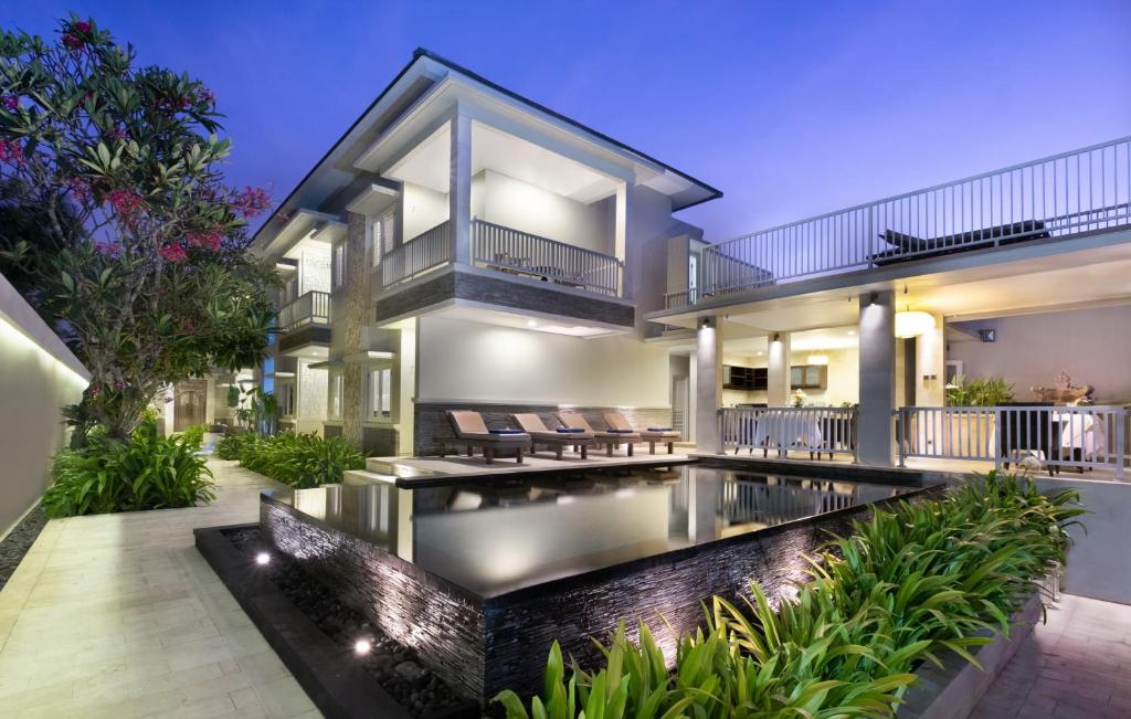 an exterior view of a house with a swimming pool at The Village Home in Sanur