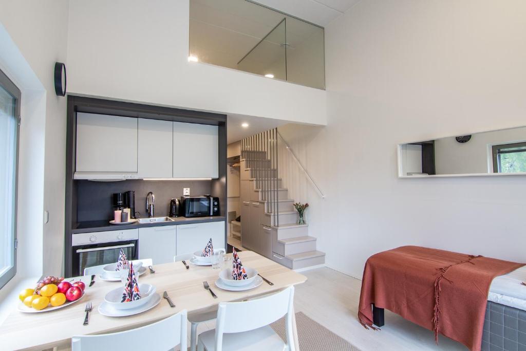 a kitchen and living room with a table and chairs at Spot Apartments Tikkurila in Vantaa
