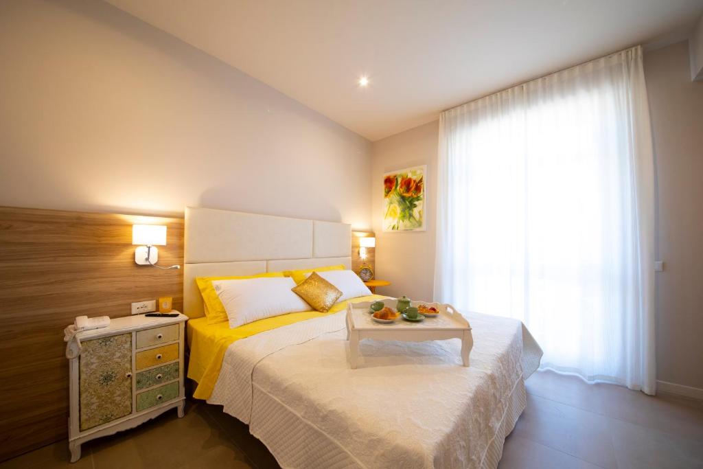 a bedroom with a bed with a table on it at Apart-Hotel la Rocchetta in Padenghe sul Garda