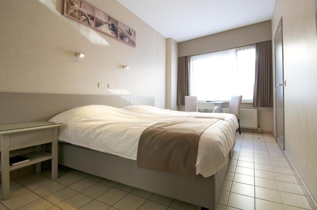 Postel nebo postele na pokoji v ubytování Hotel De Golf