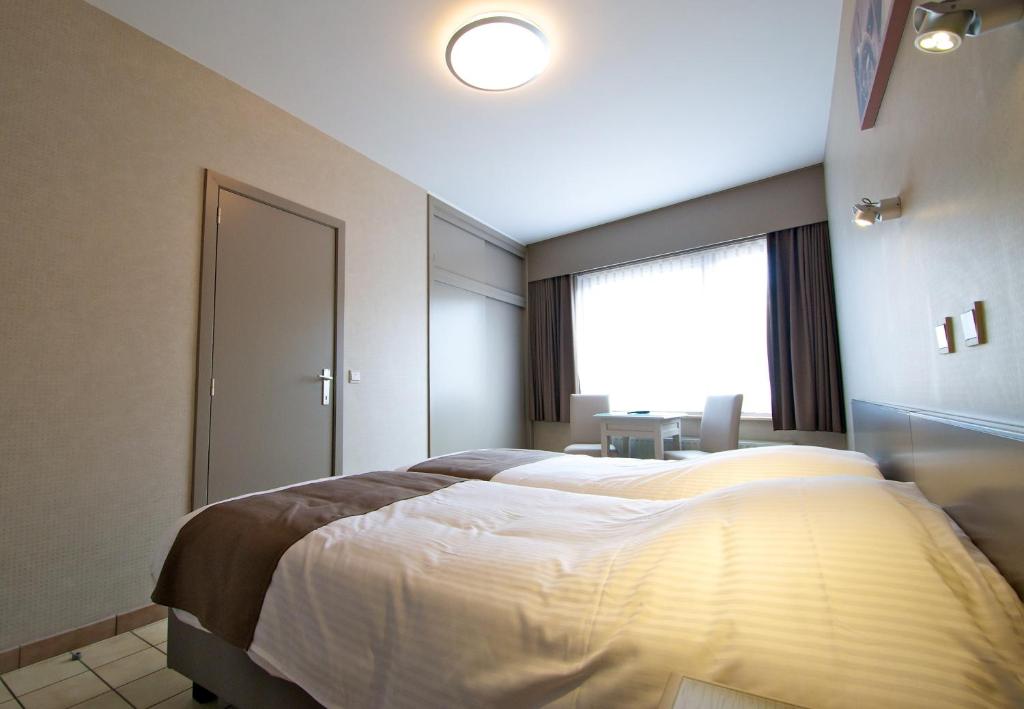 Postel nebo postele na pokoji v ubytování Hotel De Golf