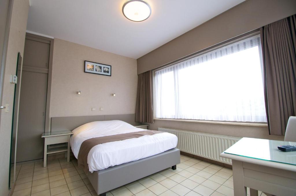 Postel nebo postele na pokoji v ubytování Hotel De Golf