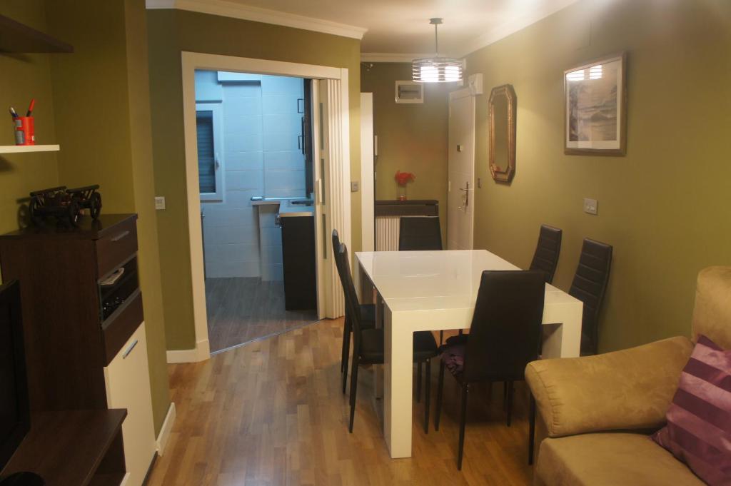 a kitchen and dining room with a table and chairs at Apartamento La Paz de Versalles in Avilés