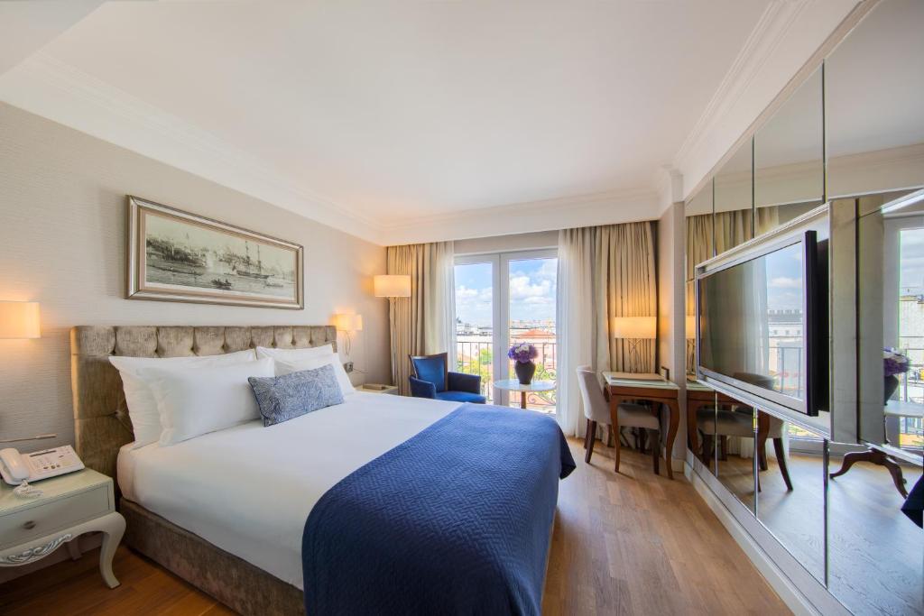 A bed or beds in a room at CVK Taksim Hotel Istanbul