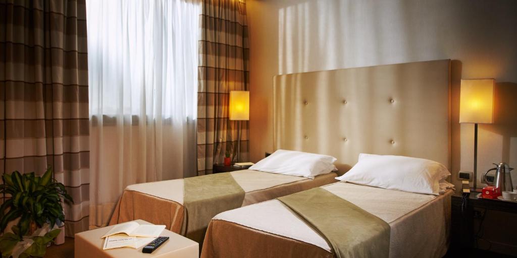 Postel nebo postele na pokoji v ubytování Hotel Pisa Valdera