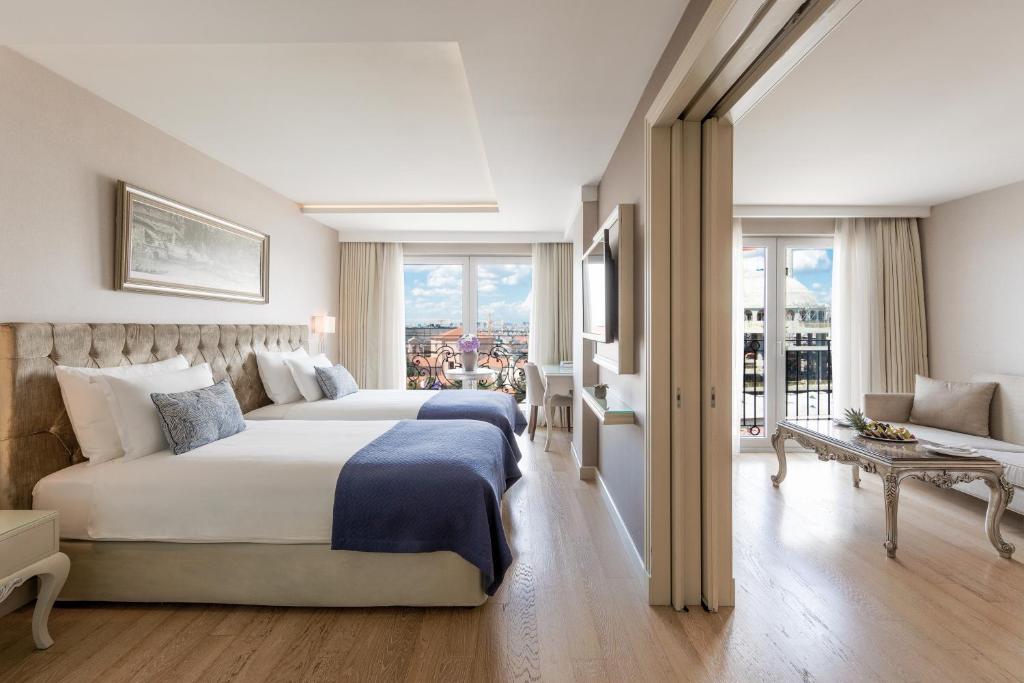 A bed or beds in a room at CVK Taksim Hotel Istanbul