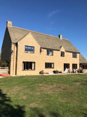 a large brick house with a lawn in front of it at Weston Grounds Farm in Bicester