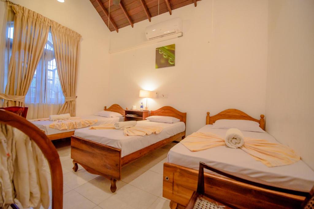 Postel nebo postele na pokoji v ubytování Muhsin Villa - Galle Fort