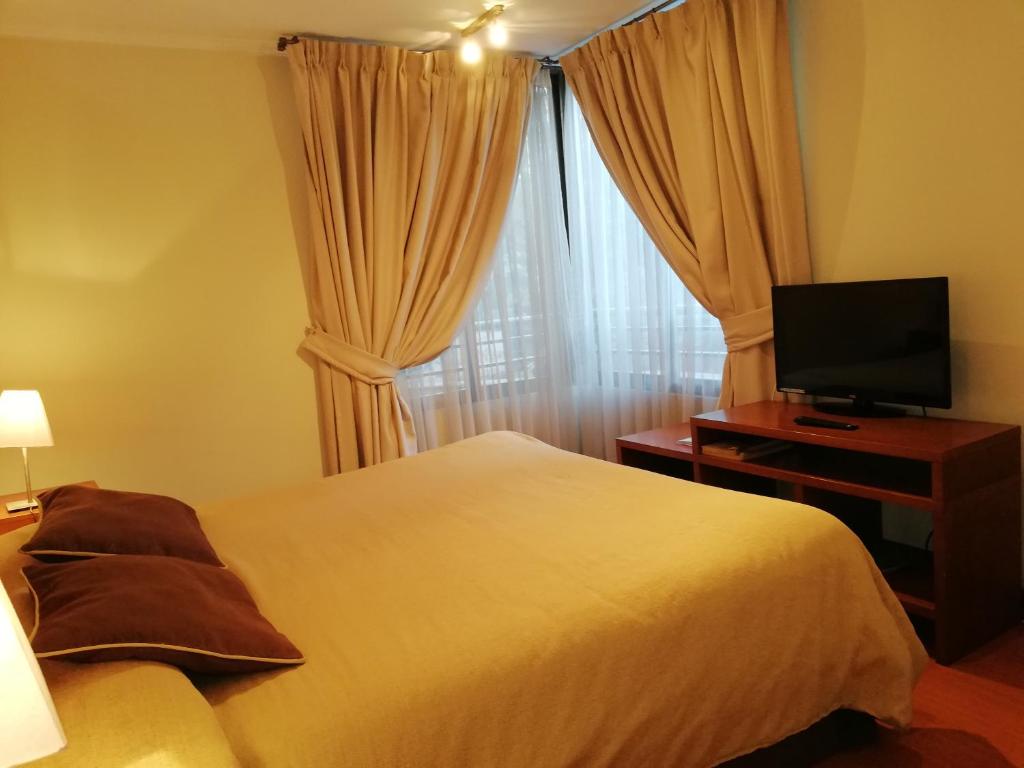 Postel nebo postele na pokoji v ubytování Andes Suites