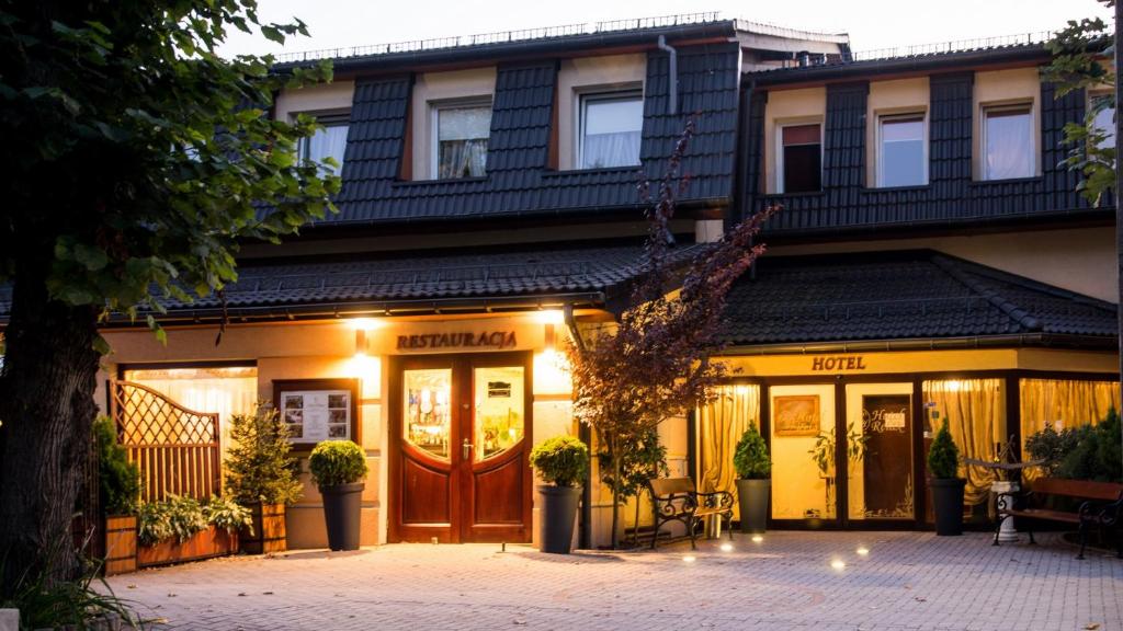 a store front of a building with a porch at Hotel Relax in Kęty