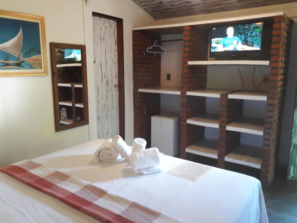 Cama ou camas em um quarto em Pousada Macunaima
