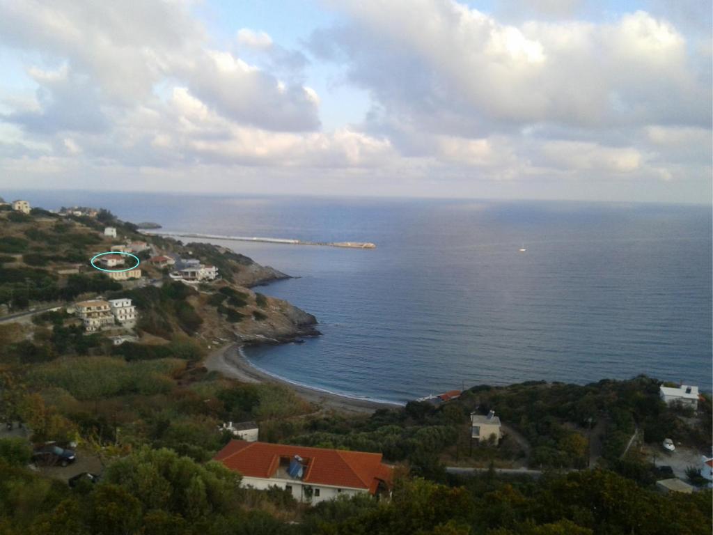 an aerial view of the ocean and a beach at The House of Summer Winds in Evdilos