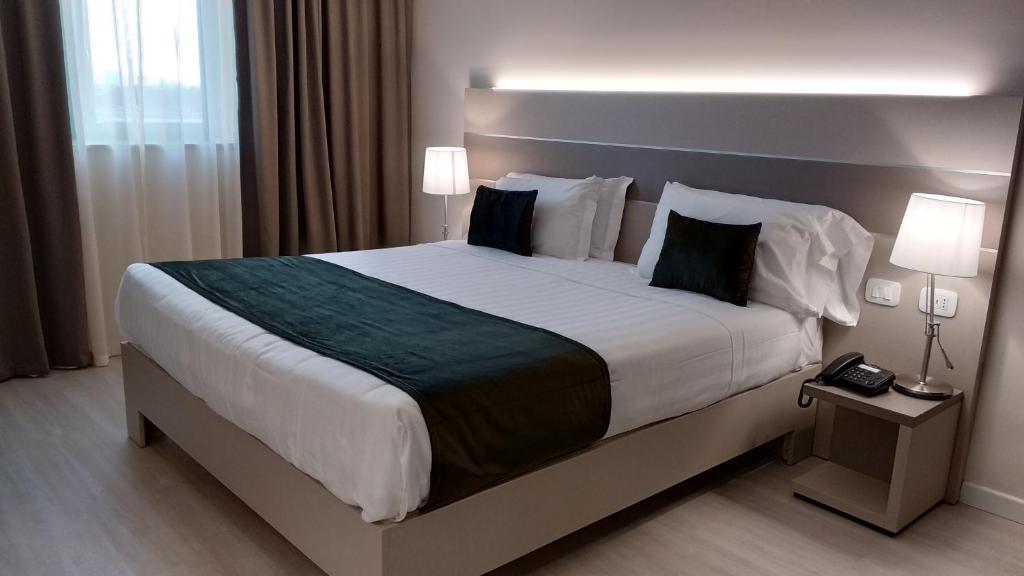 Postel nebo postele na pokoji v ubytování Hotel Glis