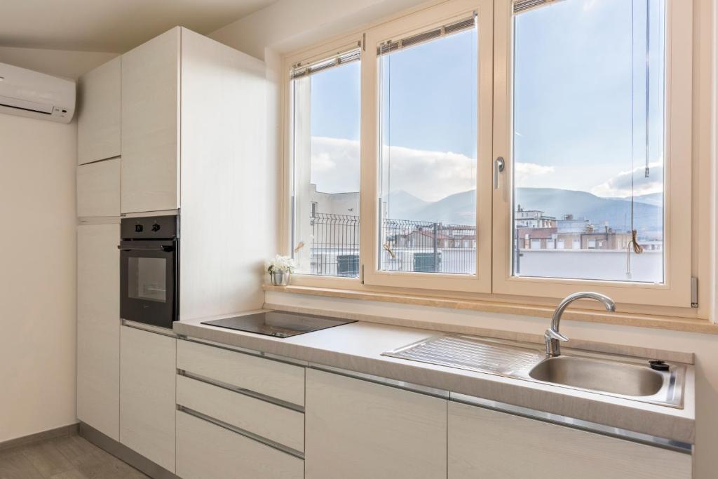 a kitchen with a sink and a window at Il Nido - Miniattico panoramico by AppartamentiPetrucci in Foligno