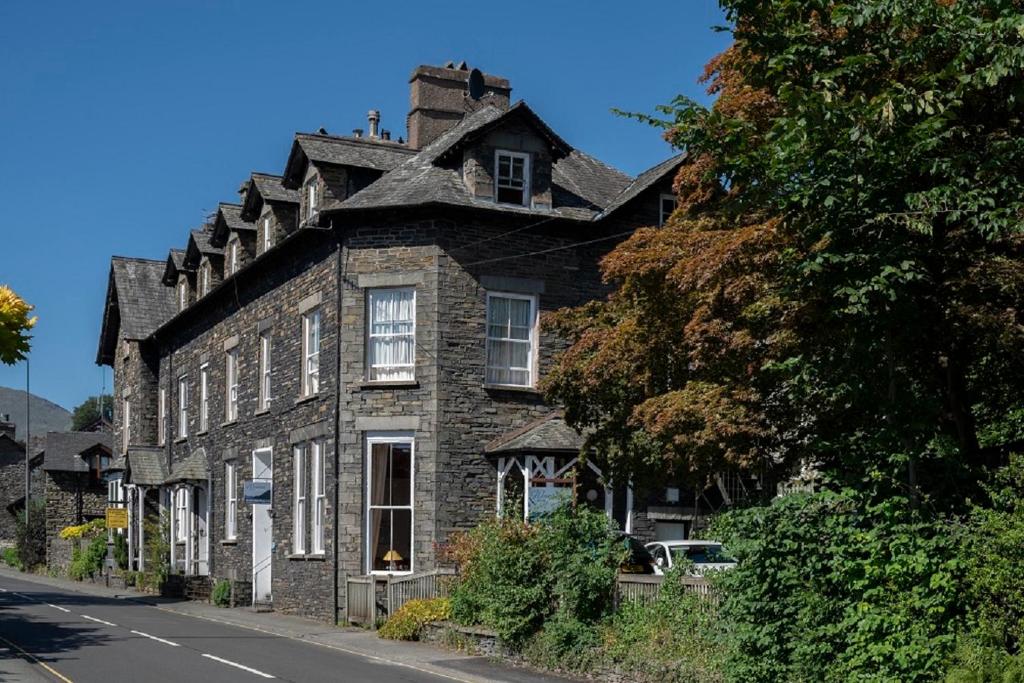 an old stone house on the side of a street at Wanslea Guest House in Ambleside