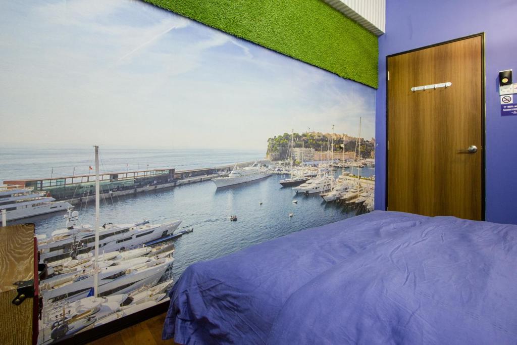a bedroom with a view of a harbor with boats at USM Designer Dwell in George Town