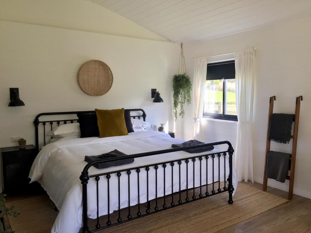 a bedroom with a bed and a window at The Retreat in Nicholls Rivulet