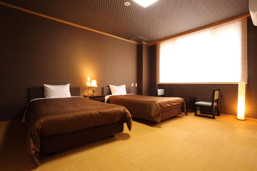 Postel nebo postele na pokoji v ubytování Hotel Oak Forest