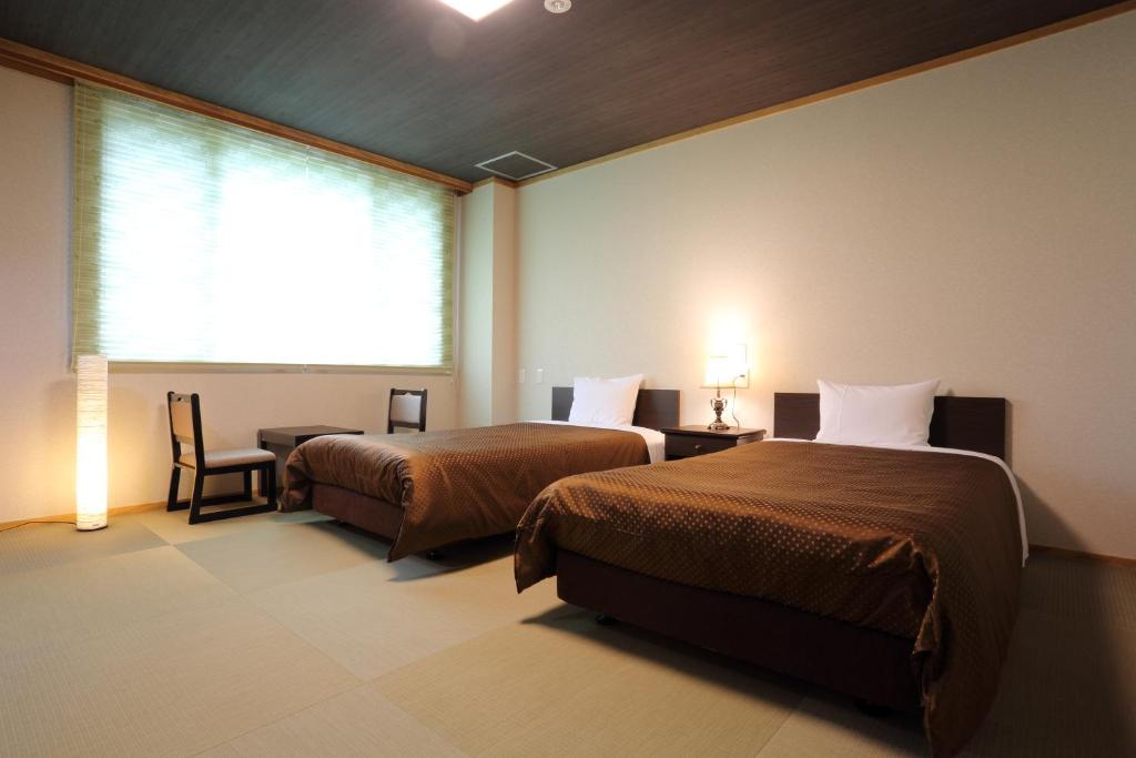 Postel nebo postele na pokoji v ubytování Hotel Oak Forest