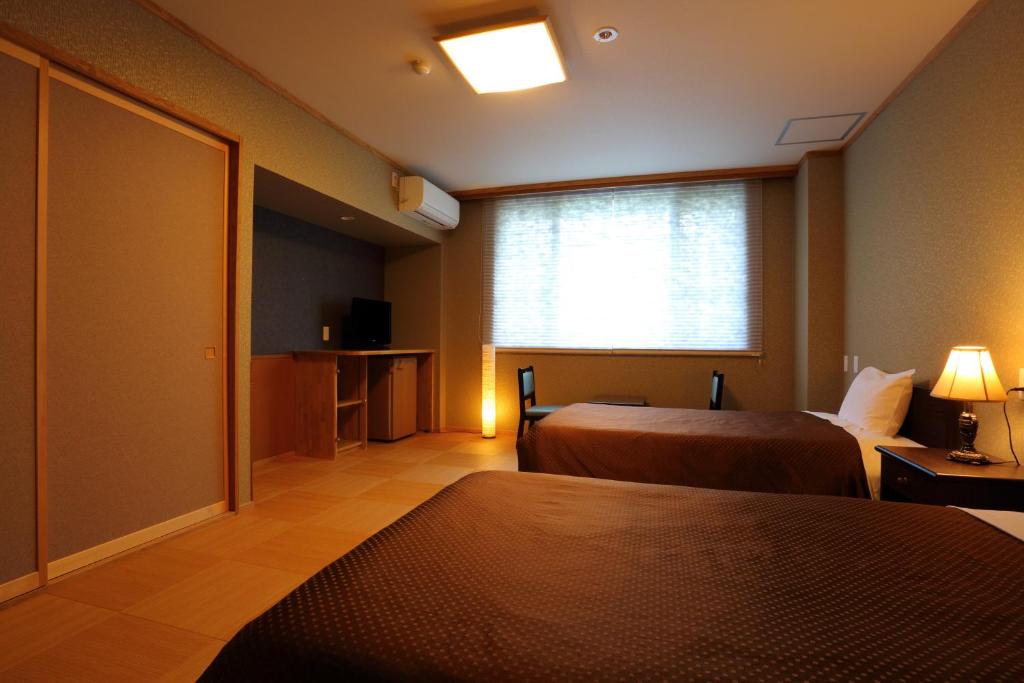 Postel nebo postele na pokoji v ubytování Hotel Oak Forest
