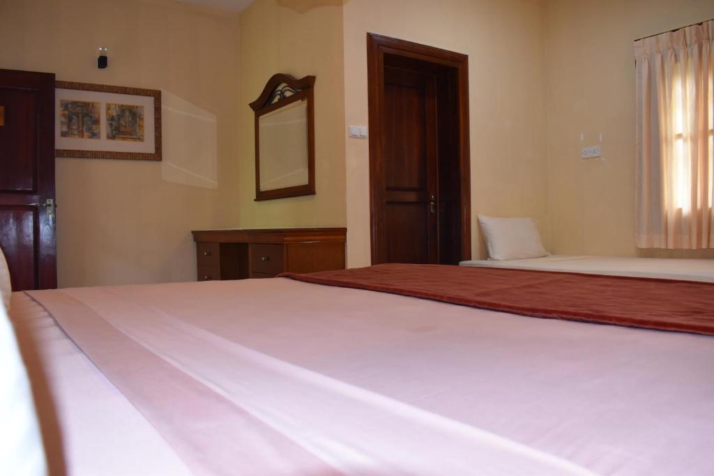 Postel nebo postele na pokoji v ubytování Hotel 4 U Saliya Garden