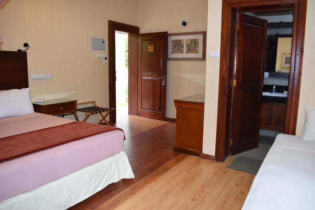 Postel nebo postele na pokoji v ubytování Hotel 4 U Saliya Garden