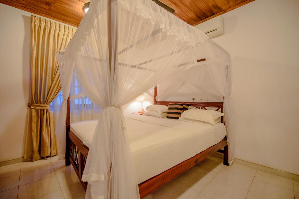 Postel nebo postele na pokoji v ubytování Muhsin Villa - Galle Fort