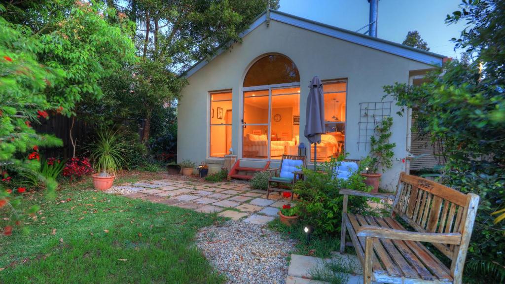 a small house with a bench in the yard at The Avenue at Montville Cottage in Montville